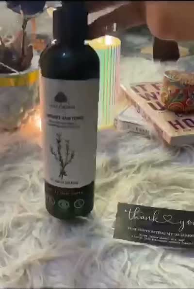 The Rosemary Hair Toner unwrapped from its parcel, beside a printed thank-you card